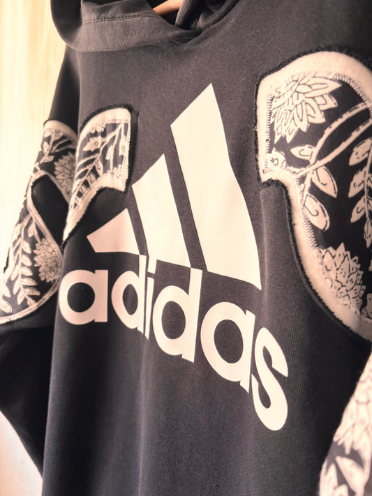 Black Adidas hoodie with white logo and floral patterns on sleeves