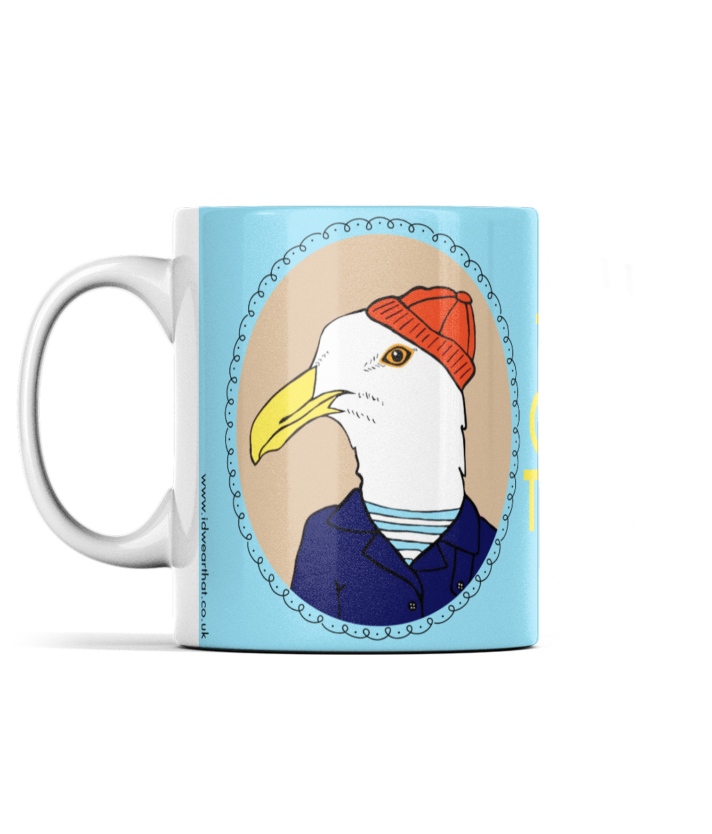 Left side view of mug with seagull dressed in fisherman hat and fisherman coat