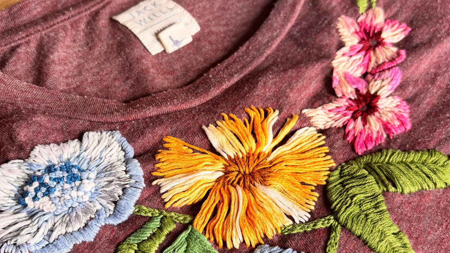 Upcycled t-shirt with colourful hand embroidered flowers and leaves 