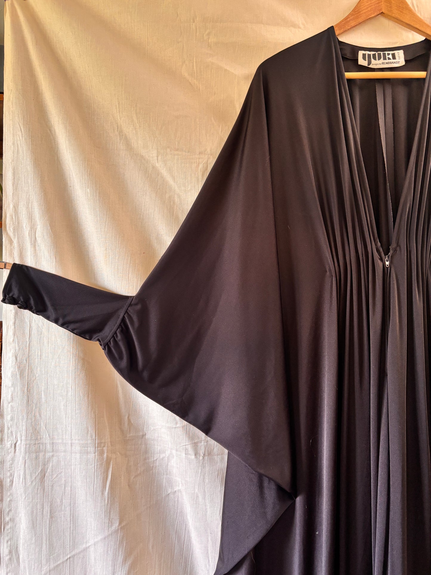 sleeve detail of Yuki for Rembrandt black zip-front kaftan with fitted cuffs
