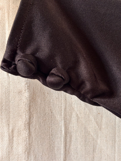 close up of buttons on cuffs of Yuki for Rembrandt black zip-front kaftan