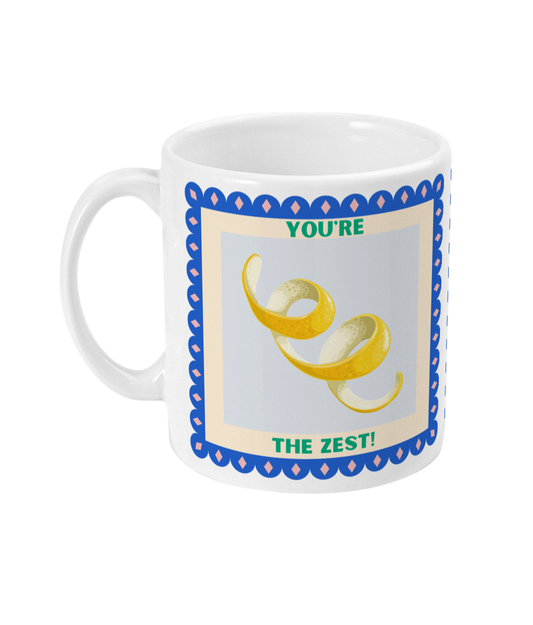 Left side view of 11oz coffee mug with lemon peel design with 'You're the Zest!'